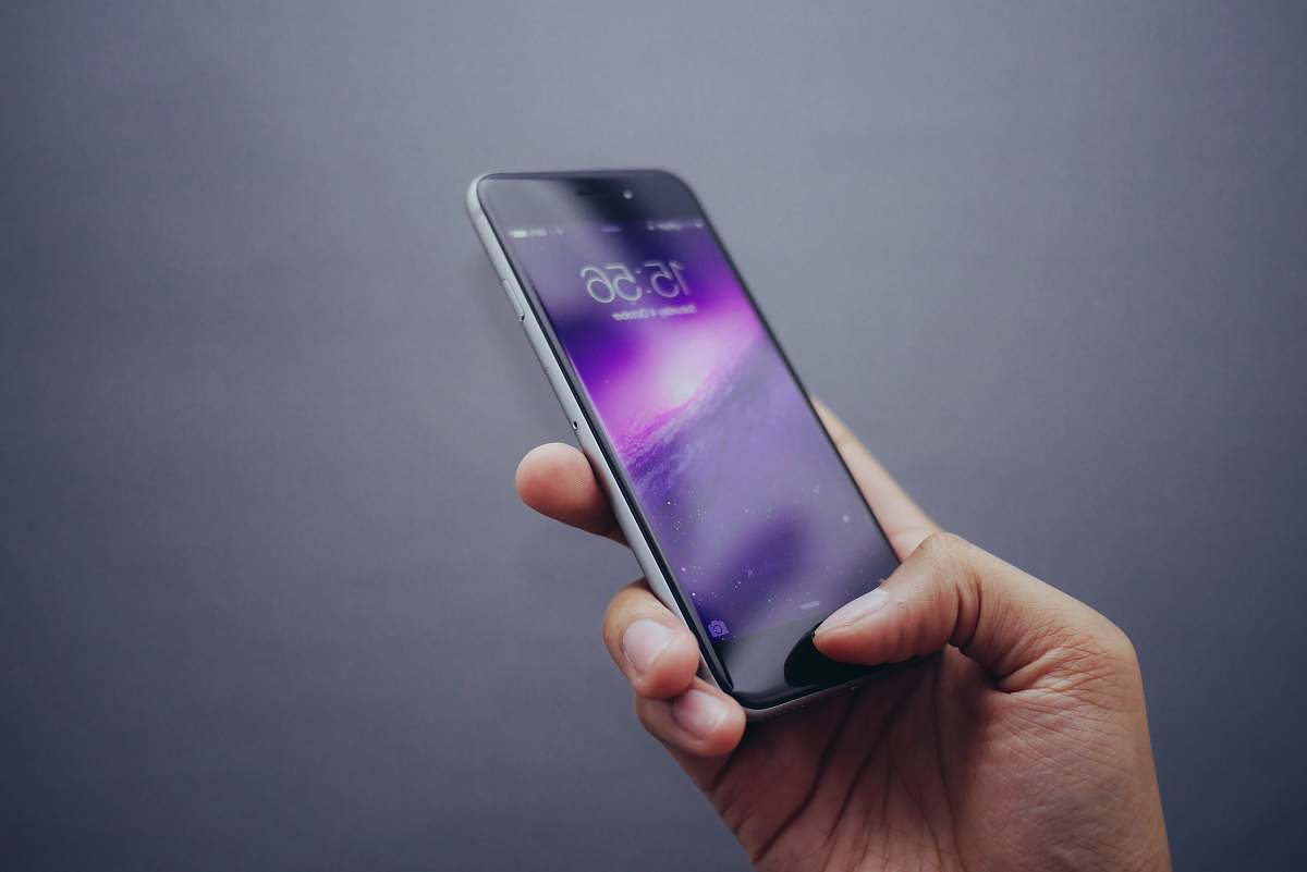 cell phone person holding space gray iPhone X iphone